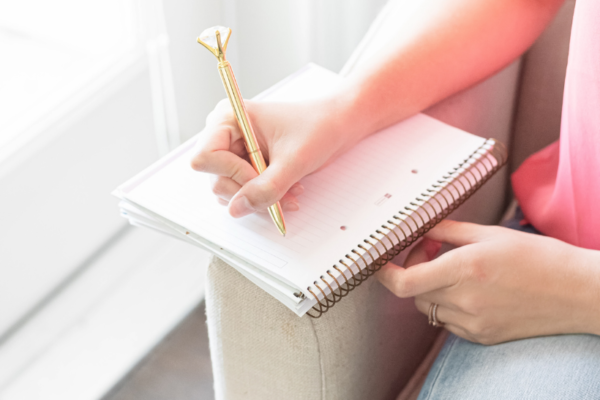 Woman taking notes. How to use a Wheel of Life Assessment to check in on your goals. MarvaSmith.com